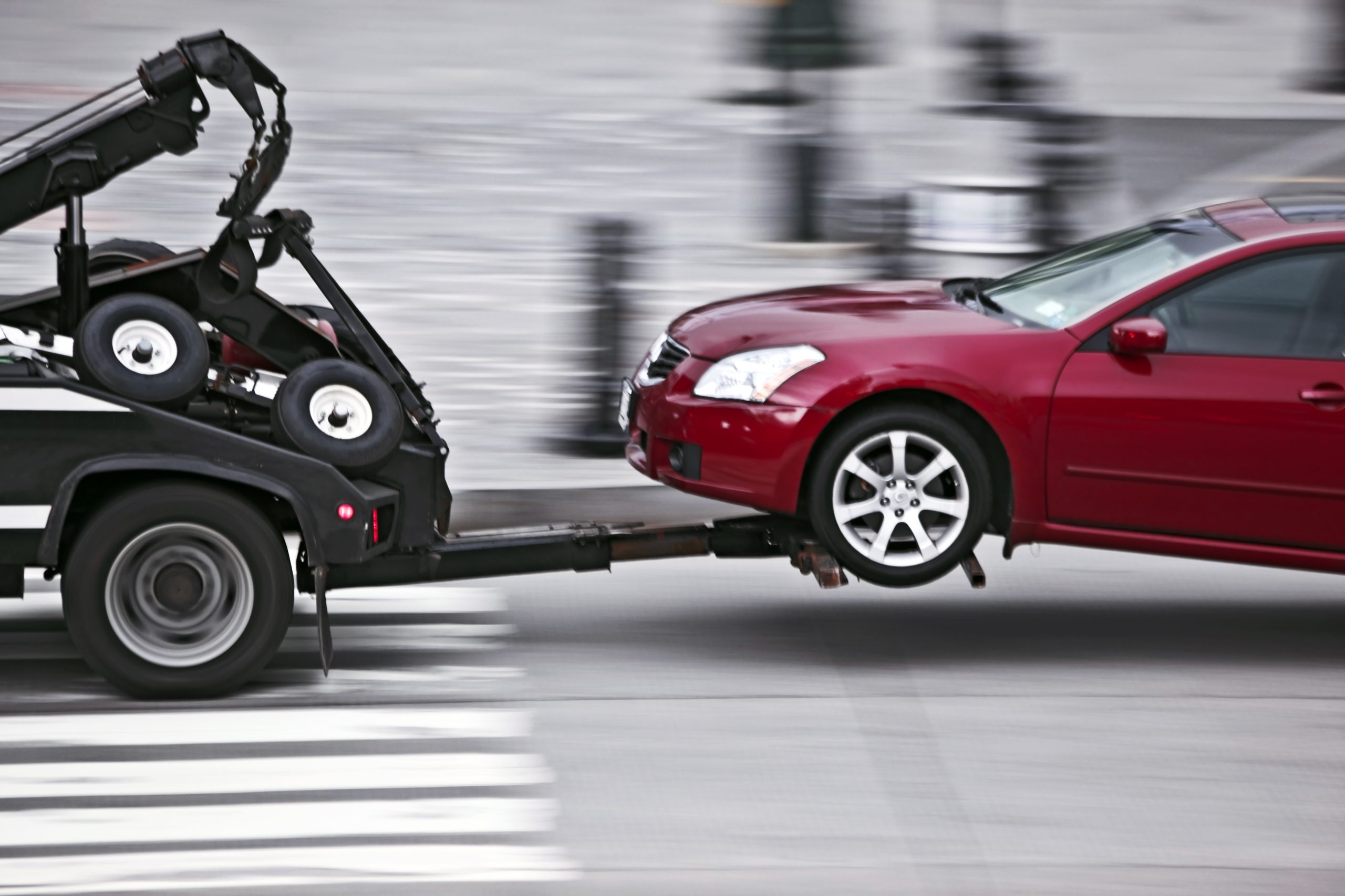 Tow Truck Delivers The Damaged Vehicle