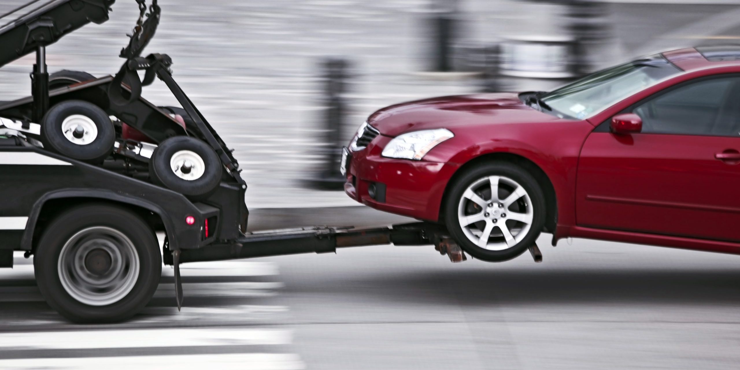 Tow Truck Delivers The Damaged Vehicle